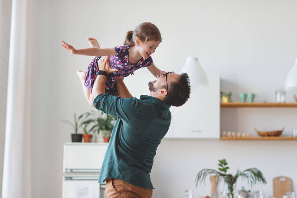 Happy family daughter hugs his dad on holiday